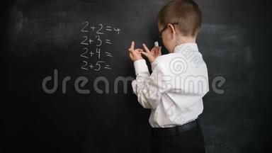 小男孩在黑板上解决数学表达。 创意理念<strong>回校</strong>学习.. 学前教育